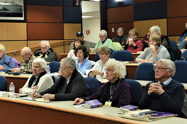 Members of the WISE program take a class at Assumption.