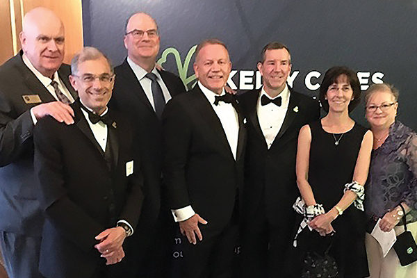 Brian Kelly ’83 (CENTER) with fellow members of the Class of 1983 Dave Conroy, Joe Manning, Michael and Cathy (Thomas) Sullivan, Assumption President Francesco C. Cesareo, Ph.D., and Melanie Demarais HA’92 at the Irish Eyes Gala in May.