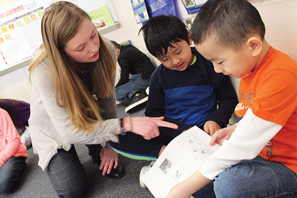 Stephanie Cota ’19 works with students at Canterbury Street Computer-Based Magnet School.