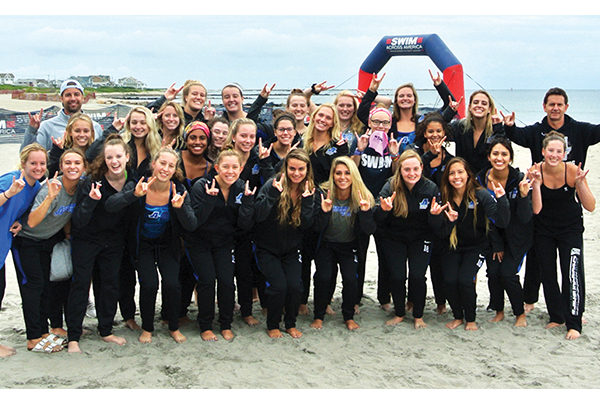 The Assumption Women's Swimming & Diving team at Swim Across America’s event at Wheeler State Beach in Narragansett, RI.