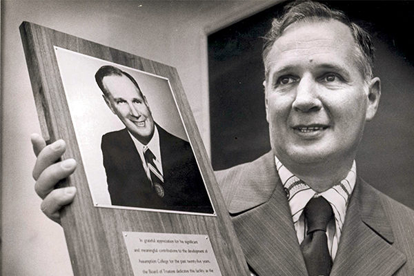 Coach Laska holding the plaque dedicating the Laska Gymnasium in his honor in 1975.
