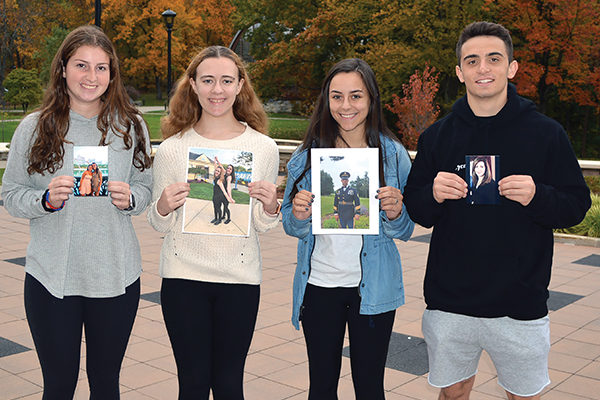 Claire DeSilva '23, Sarah Mattison '23, Markkie Fleming ;23, and Matthew Naughton '23 hold photos of their interview subjects.