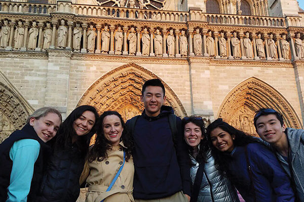 Brianna Murphy (third from left) with students  at Notre Dame Cathedral in Paris during a  World War II-themed tour she led in April 2017.