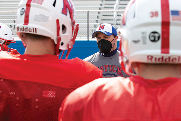 Nicholas DiAntonio '12 runs defensive drills during a Natick High School football practice.